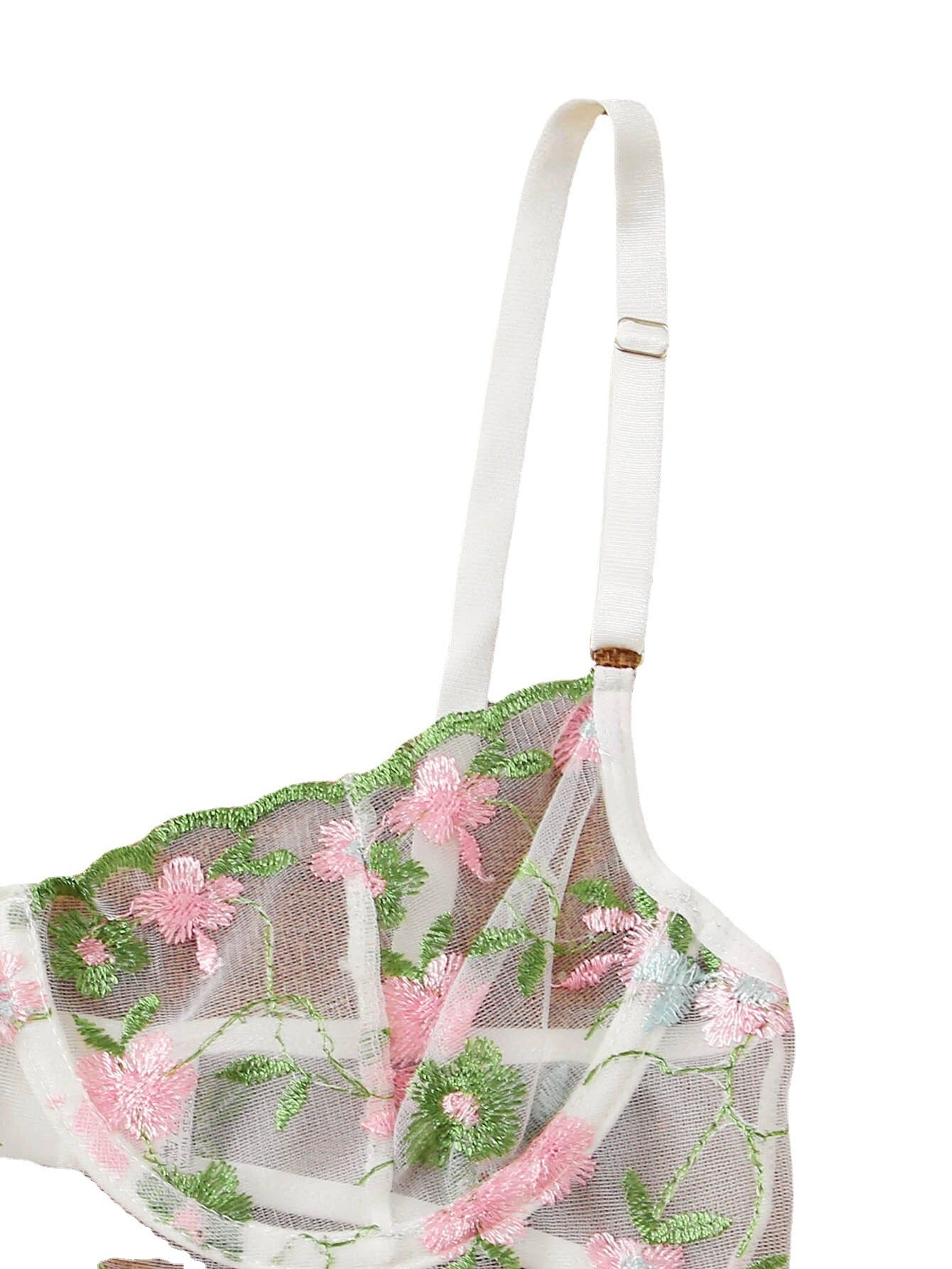 Back view of woman in black mesh lingerie set showing garter belt straps and thong design